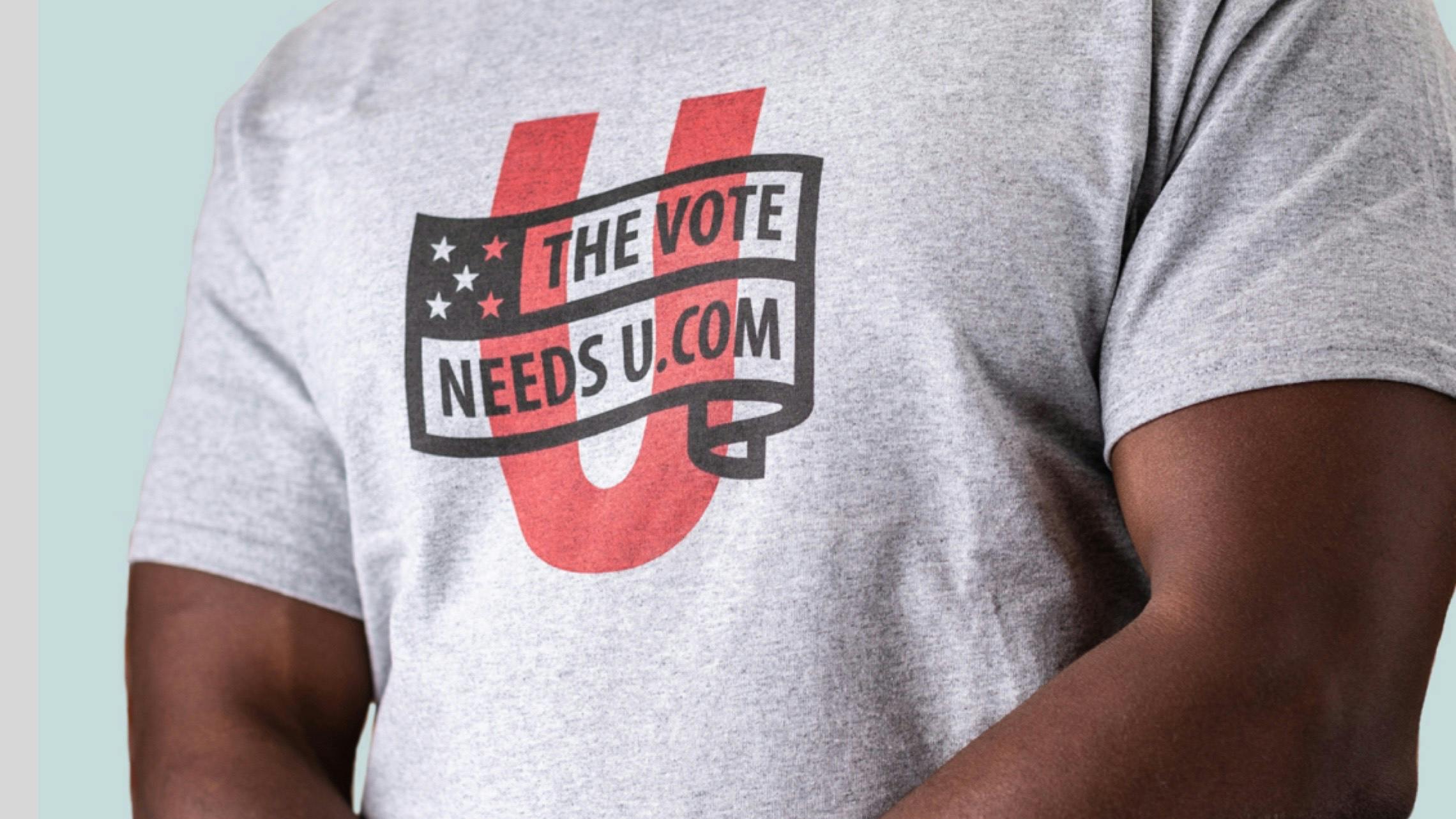 Photograph of a man wearing a "The Vote Needs U" shirt.